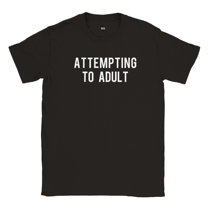 Black slogan tshirt which says Attempting to Adult on white background
