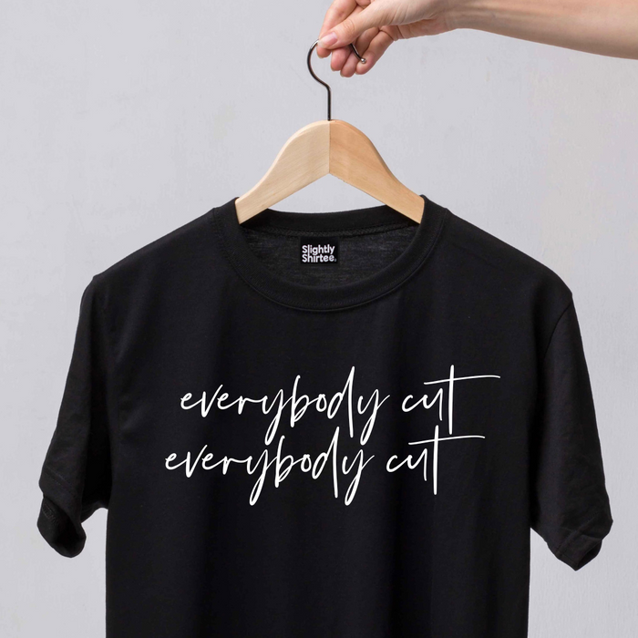 Black slogan tee on a white background. Slogan says everybody cut as a reference to the 80s movie footloos